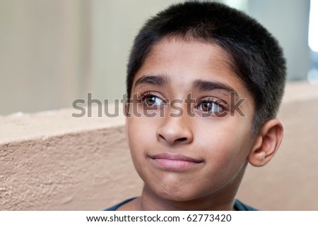 an handsome Indian kid day dreaming
