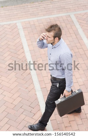 Businessman with briefcase walking in the street.