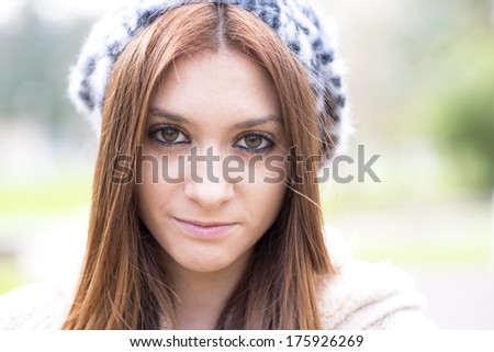 Closeup portrait of attractive young girl with bonnet.