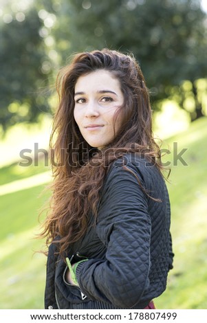 Portrait of attractive girl, the wind fluttering hair, outdoor.