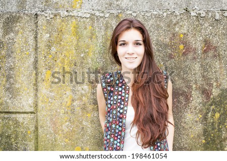 Portrait of smiling hippie woman on urban background.