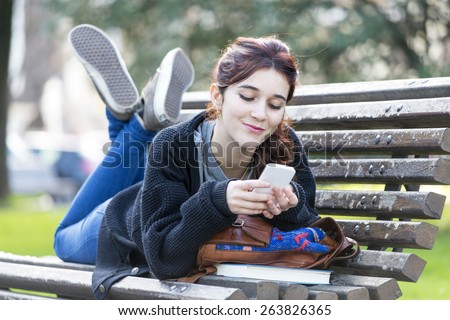 Smiling beautiful young woman looking message on phone, feeling and emotion lifestyle concept.