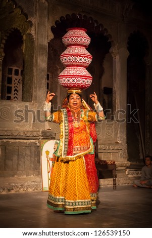 UDAIPUR, INDIA - NOVEMBER 24: Bhavai performance - famous folk dance of Rajasthan state of India. Performer balances number of earthen pots as she dance. November 24, 2012 in Udaipur, Rajasthan, India