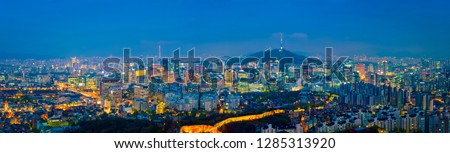 Panorama of Seoul downtown cityscape illuminated with lights in the evening view from Inwang mountain. Seoul, South Korea.