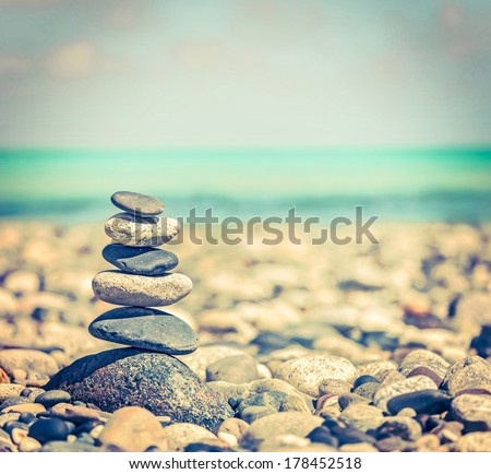 Vintage Retro Hipster Style Travel Image Of Zen Meditation Background - Balanced Stones Stack Close Up On Sea Beach