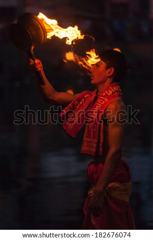 UJJAIN, INDIA - APRIL 24:, 2011 Brahmin performing Aarti pooja ceremony on bank of holy river Kshipra. Aarti is Hindu religious ritual of worship, part of puja when light is offered to deities