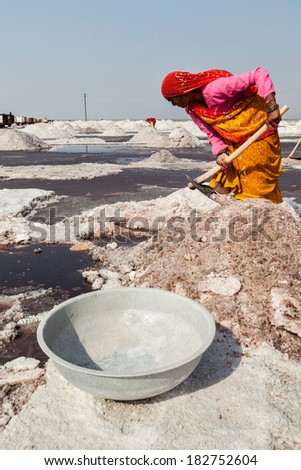 SAMBHAR, INDIA - NOVEMBER 19, 2012: Women mining salt at lake Sambhar, Rajasthan, India. Sambhar Salt Lake is India\'s largest inland salt lake