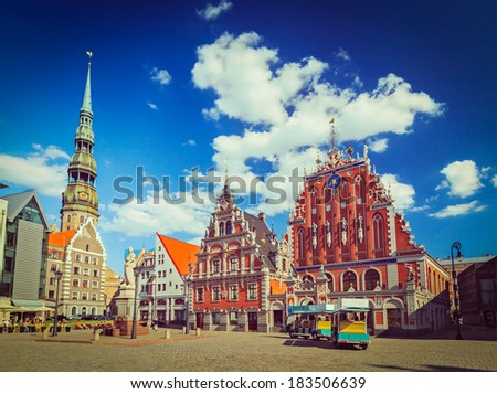 Vintage retro hipster style travel image of Riga Town Hall Square, House of the Blackheads and St. Peter\'s Church, Riga, Latvia