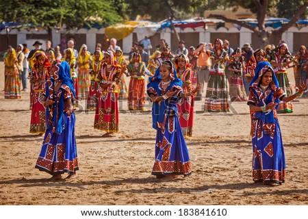 PUSHKAR, INDIA - NOVEMBER 21, 2012: Unidentified Rajasthani girls in traditional outfits dancing at annual camel fair  Pushkar Mela in Pushkar, Rajasthan, India