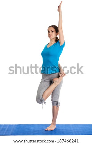 Yoga - young beautiful woman yoga instructor preparing for Half Bound Lotus Standing Forward Bend(Ardha Baddha Padmottanasana) asana exercise isolated on white background
