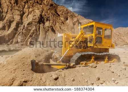 Bulldozer doing road construction in Himalayas. Ladakh, Jammu and Kashmir, India
