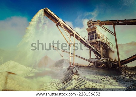 Vintage retro effect filtered hipster style image of Industrial background - crusher (rock stone crushing machine) at open pit mining and processing plant for crushed stone, sand and gravel