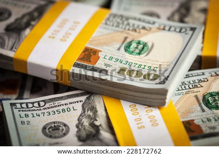 Creative business finance making money concept - background of of new 100 US dollars 2013 edition banknotes (bills) bundles close up