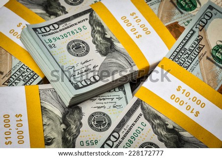 Creative business finance making money concept - background of of new 100 US dollars 2013 edition banknotes (bills) bundles close up