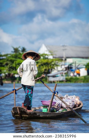CAN THO,VIETNAM - 4 JUNE, 2011: Unidentified woman at floating market in Mekong river delta. Cai Rang and Cai Be markets are central markets in delta and became  popular tourist destination
