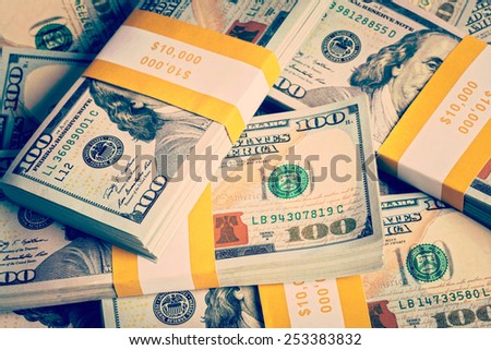 Creative business finance making money concept - Vintage retro effect filtered hipster style image of background of of new 100 US dollars 2013 edition banknotes (bills) bundles close up