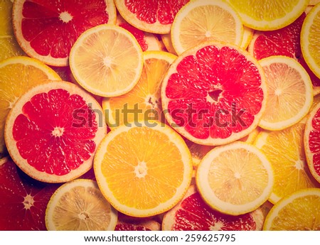 Vintage retro effect filtered hipster style image of colorful citrus fruit - lemon, orange, grapefruit - slices background