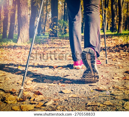 Close up of hinking woman feet and nordic walking poles. Vintage retro effect filtered hipster style image