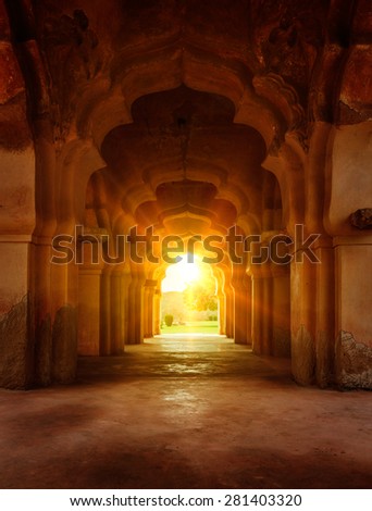 Old ruined arch in ancient palace at sunset, India