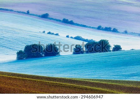 Rolling landscape of green fields in South Moravia, Czech Republic in early morning