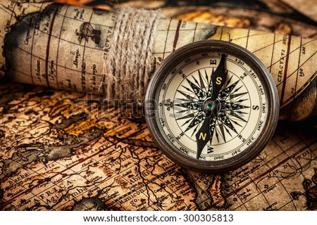 Travel geography navigation concept background - old vintage retro compass on ancient world map