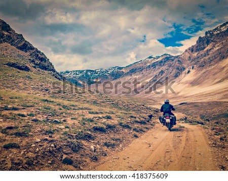 Vintage retro effect filtered hipster style image of motorcycle bike on mountain road in Himalayas. Spiti Valley, Himachal Pradesh, India