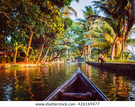 Vintage retro effect hipster style image of Kerala backwaters tourism travel in canoe. Kerala, India