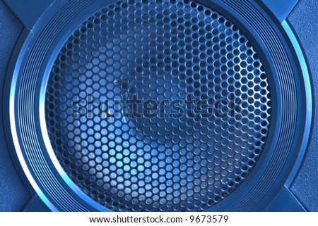 Blue tinted loud speaker with grille close up