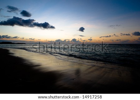 Calm peaceful ocean and beach on tropical sunrise