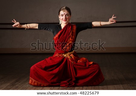 Young woman in sari dancing classical traditional indian dance Bharat Natyam