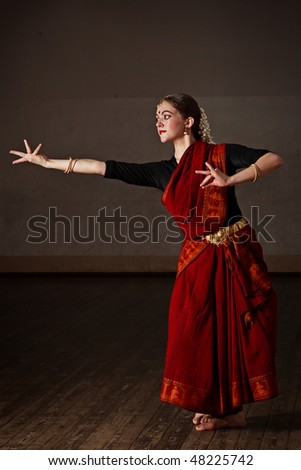 Young woman in sari dancing classical traditional indian dance Bharat Natyam