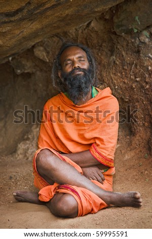 TIRUVANNAMALAI, INDIA - JANUARY 7: Sadhu (holy man) meditating in cave on Mt Arunachala on January 7, 2010 in Tiruvannamalai, Tamil Nadu, India