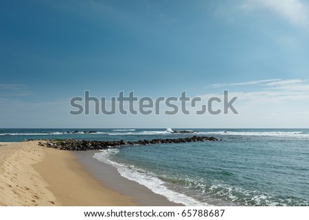 Wave breaker on beach. Mirissa, Sri Lanka