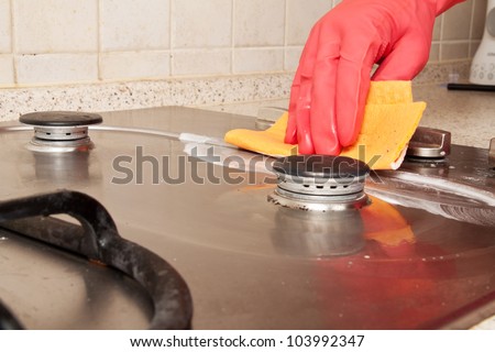 The man cleaning gas stove