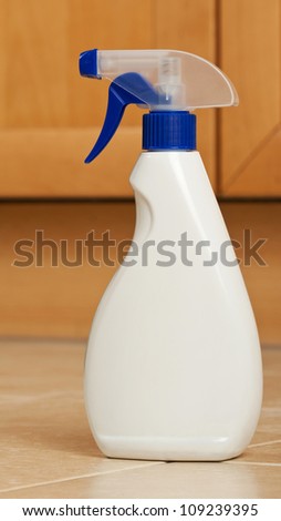Plastic spray bottle on a kitchen floor