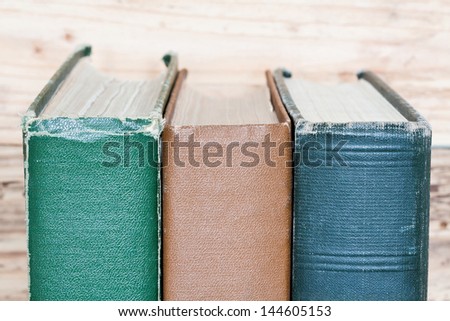 vintage books next to the wooden wall