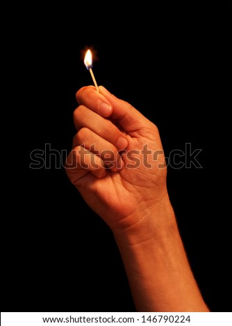 Man hand holding burning matchstick
