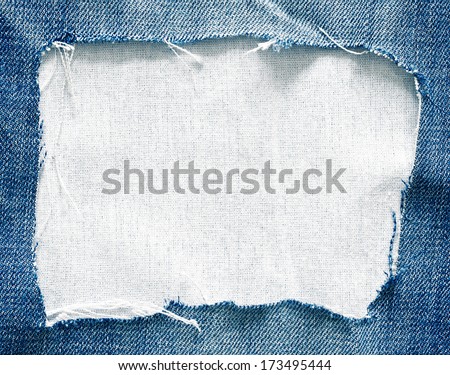 Blue torn jeans on white fabric texture