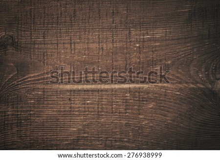 Dark brown scratched wooden cutting board. Wood texture