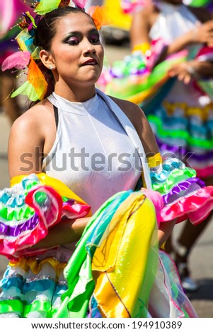 Barranquilla, Colombia - March 1, 2014 - Performers in elaborate costume sing, dance, and stroll their way down the streets of Barranquilla during the Battalla de Flores during Carnival