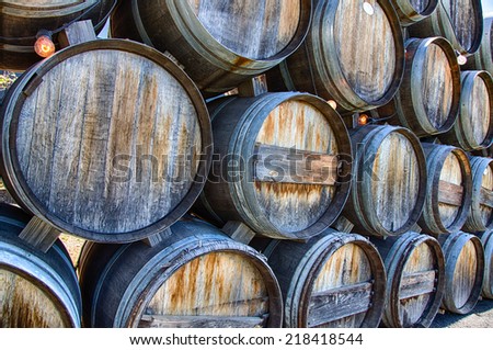 Rustic oak wine barrels stacked at a California winery.