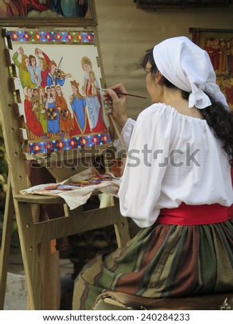 Alcala de Henares, Madrid, Spain - OCTOBER 8: woman painting a picture in medieval market held on October 8, 2014 in Alcala de Henares, Madrid, Spain