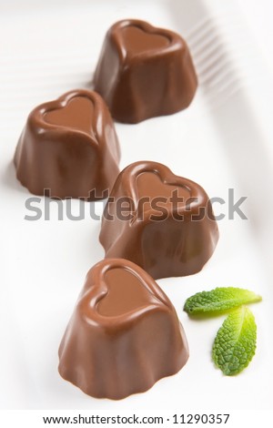 chocolate sweets Stock-photo-heart-shaped-chocolate-and-mint-leaf-11290357