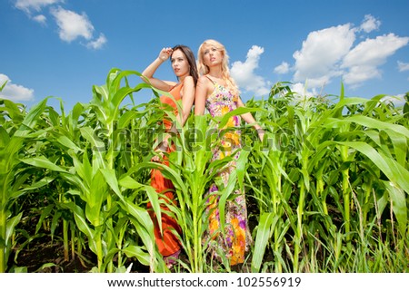 two girlfriends having fun in field