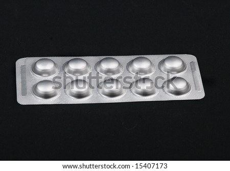 Pack of pills isolated over black background