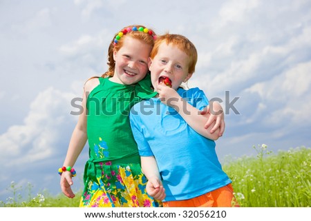Two golden-haired children playing the field