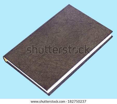 Black book with patterned hardcover lying isolated on blue background