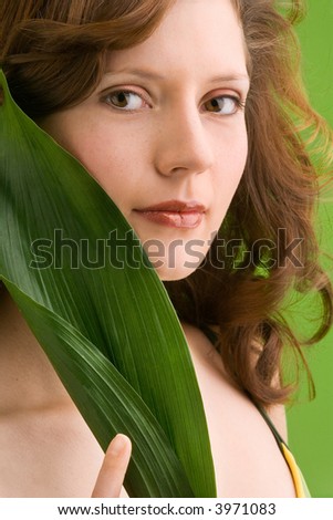 stock photo young girl in bikini is holding a leaf