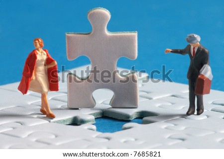 two plasticfigures standing on a puzzle with a hole in it