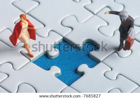 two plasticfigures standing on a puzzle with a hole in it